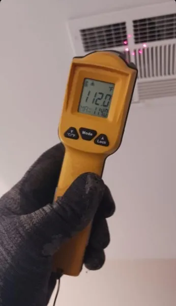 HVAC technician inspecting air conditioning system